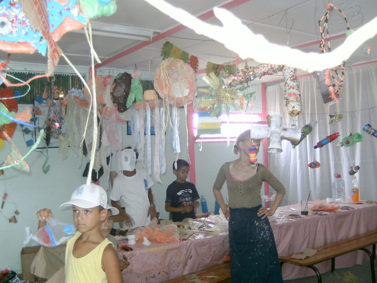 Clasroom in Marruecos with student art hanging from ceiling