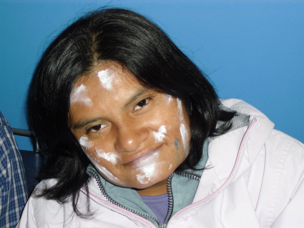 Woman with white face paint on her forehead, cheeks, and chin at HKF event